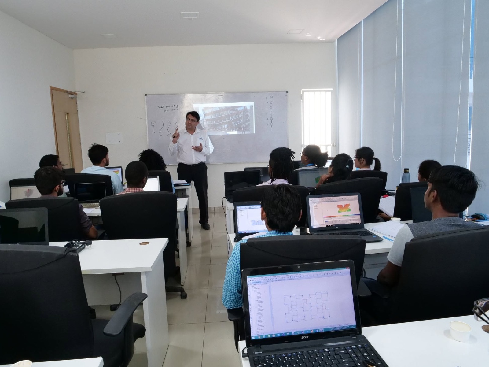 E-Construct classroom with participants working on laptops